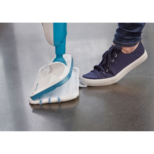 BLACKDECKER FSMH13E5 steam mop with white cleaning pad, close-up side angle on hard floor.