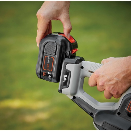 Close-up photo of BLACK+DECKER GTC5455PC cordless tool with 54V dual volt battery being attached.