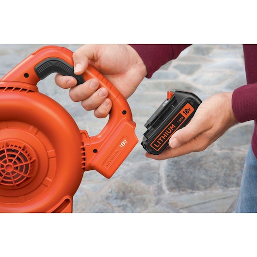 Photo of BLACKDECKER GWC1800L20 leaf blower with 18V lithium battery being inserted, close-up view.