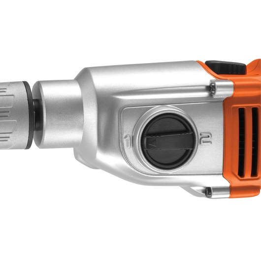 BLACKDECKER KR1102K drill close-up, side view of metallic orange body with mode selector dial, white background.