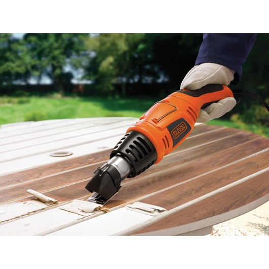 BLACKDECKER KX1693 heat gun used for paint removal on wood outdoors.