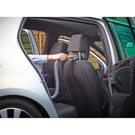 BLACKDECKER NV1210AV handheld vacuum cleaning car seat from rear passenger side.