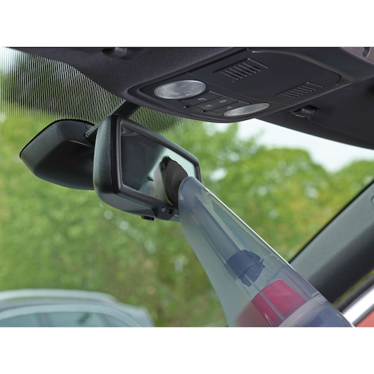 BLACKDECKER NV1210AV handheld vacuum cleaning car rearview mirror interior, close-up angle.