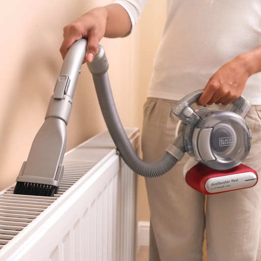 BLACKDECKER PD1020L handheld vacuum cleaning radiator with flexible hose and brush attachment.