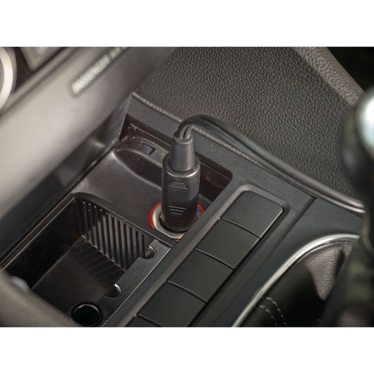 BLACKDECKER PV1200AV car vacuum cleaner power adapter plugged into a vehicle 12V socket, close-up view.