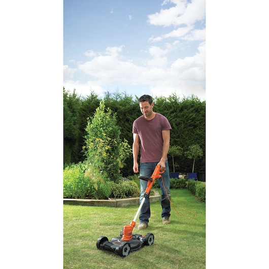 Photo of BLACKDECKER ST5530CM lawn mower being used outdoors on grass.