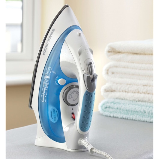 BLACK+DECKER XT2200CP steam iron with blue and white body, upright on table, folded towels in background.