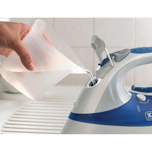 BLACKDECKER XT2200 steam iron, blue and white, water being poured into tank, close-up angle
